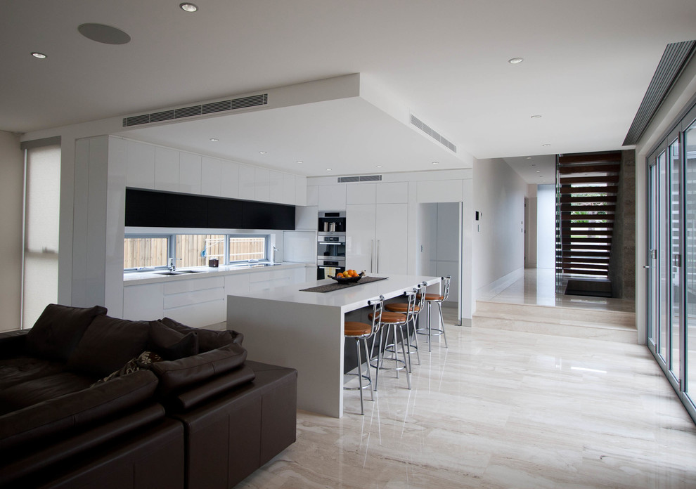 This is an example of a contemporary kitchen in Sydney with an island.