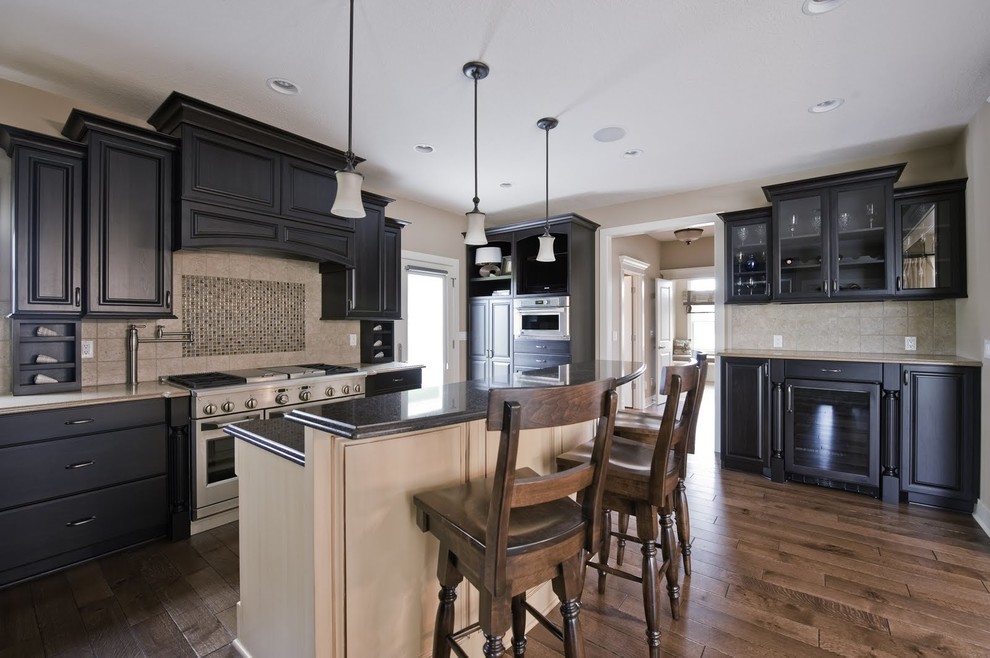 Example of a large arts and crafts l-shaped medium tone wood floor eat-in kitchen design in Grand Rapids with recessed-panel cabinets, black cabinets, granite countertops, mosaic tile backsplash, stainless steel appliances and an island