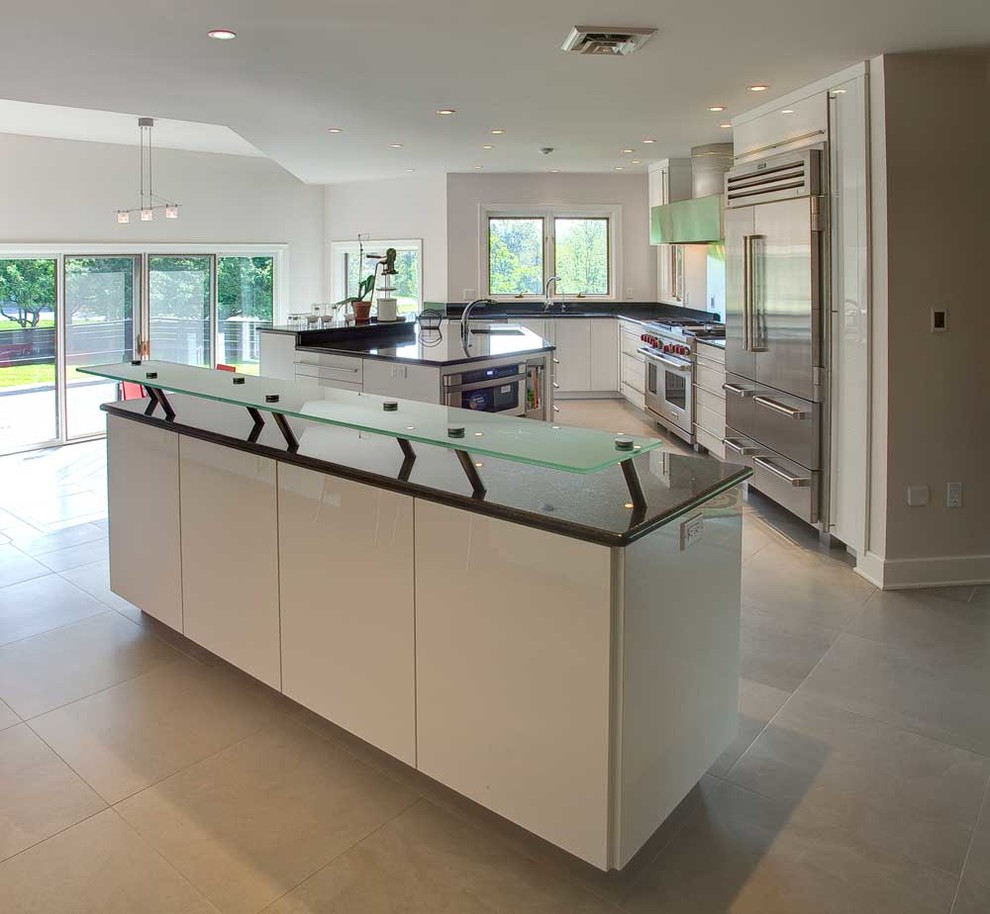 Inspiration for a large contemporary l-shaped kitchen/diner in Philadelphia with a submerged sink, flat-panel cabinets, white cabinets, granite worktops, stainless steel appliances, ceramic flooring and multiple islands.