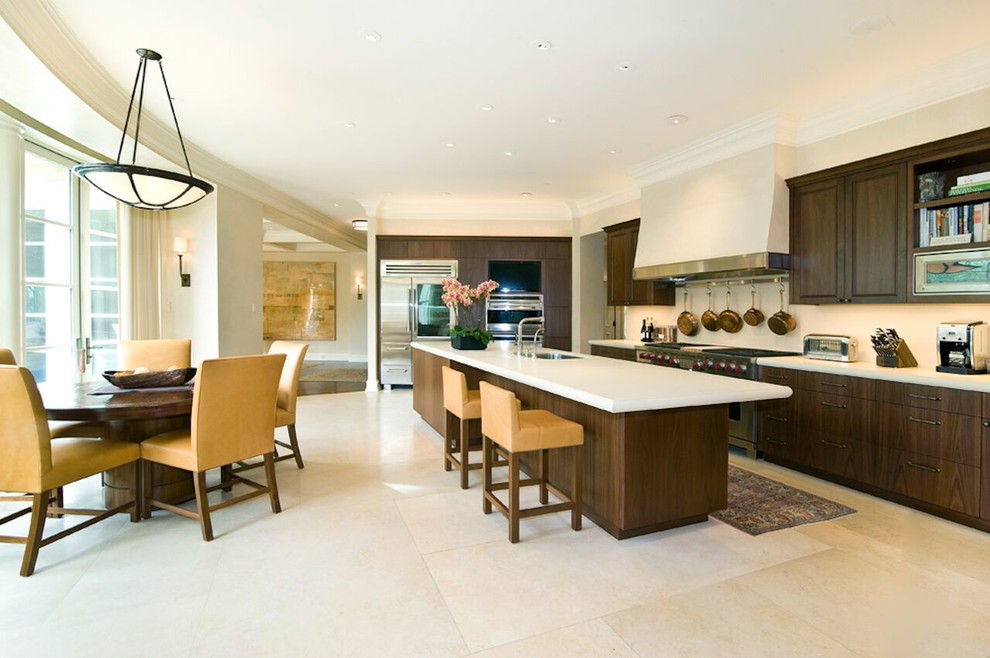 Inspiration for a large transitional l-shaped porcelain tile eat-in kitchen remodel in San Francisco with an undermount sink, raised-panel cabinets, dark wood cabinets, quartz countertops, stainless steel appliances and an island