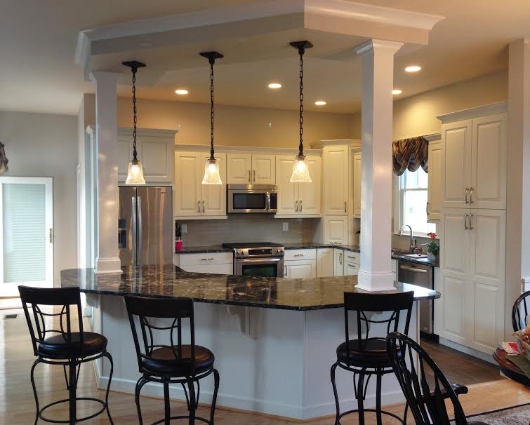 Mid-sized transitional u-shaped dark wood floor and brown floor enclosed kitchen photo in Baltimore with a double-bowl sink, raised-panel cabinets, white cabinets, granite countertops, white backsplash, subway tile backsplash, stainless steel appliances and a peninsula