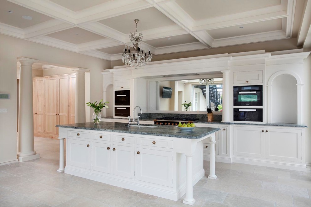 Inspiration for a large traditional galley kitchen in Dublin with shaker cabinets, white cabinets, quartz worktops, mirror splashback, black appliances, ceramic flooring, an island, grey floors, green worktops and a submerged sink.