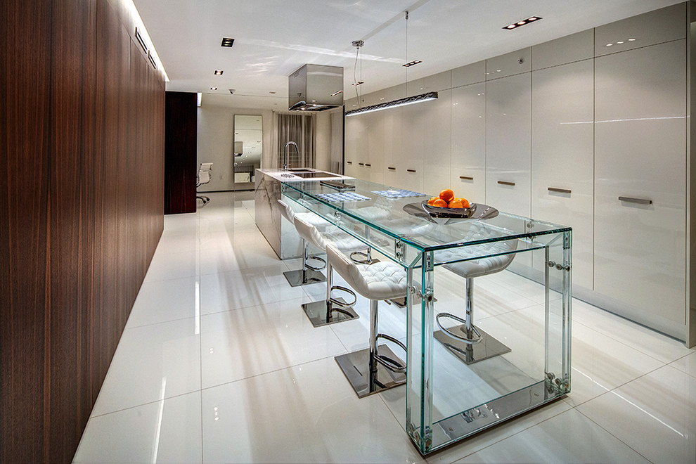 Contemporary kitchen in Los Angeles with a submerged sink, flat-panel cabinets, grey cabinets, multiple islands and white floors.