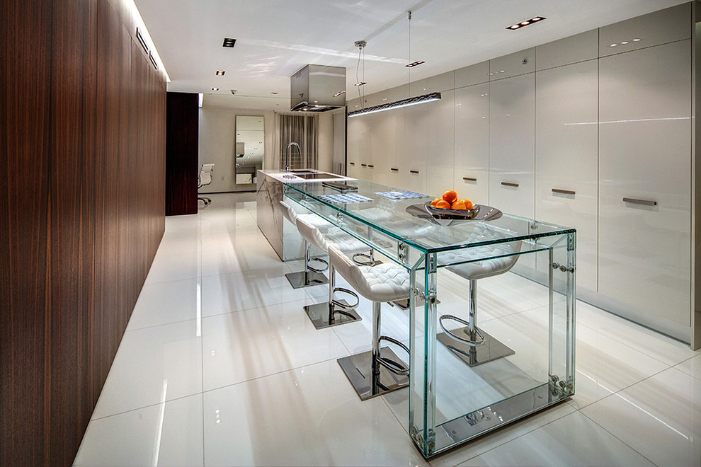 Inspiration for a contemporary white floor kitchen remodel in Los Angeles with an undermount sink, flat-panel cabinets, gray cabinets and two islands