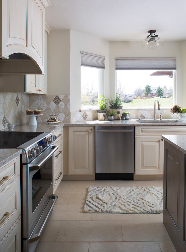 Inspiration for a medium sized traditional galley kitchen in Denver with a submerged sink, engineered stone countertops, multi-coloured splashback, ceramic splashback, stainless steel appliances, travertine flooring, an island and beige floors.