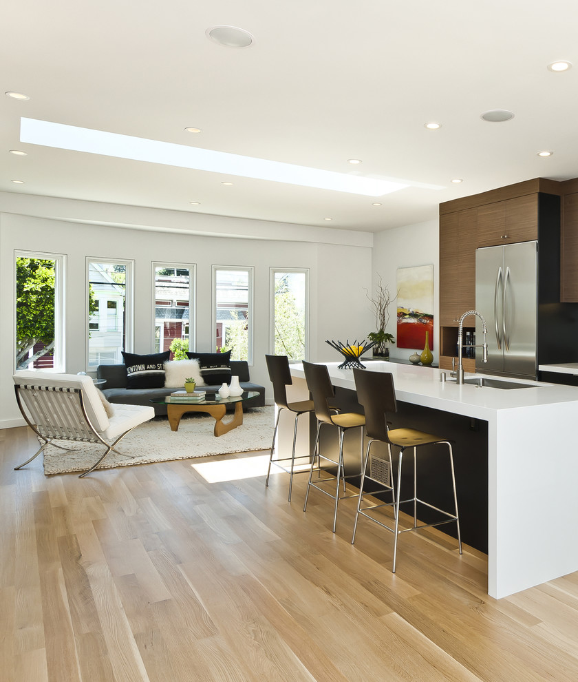 Photo of a contemporary galley open plan kitchen in San Francisco with a submerged sink, flat-panel cabinets, medium wood cabinets and stainless steel appliances.