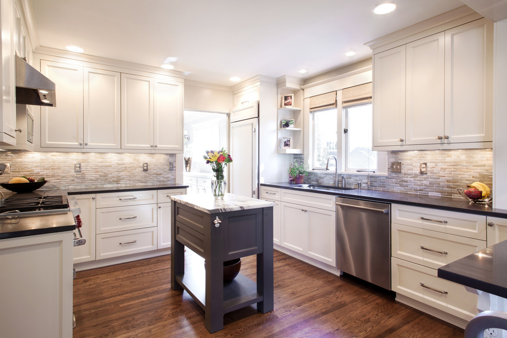 Example of a mid-sized classic u-shaped medium tone wood floor eat-in kitchen design in Portland with a single-bowl sink, recessed-panel cabinets, white cabinets, quartz countertops, blue backsplash, mosaic tile backsplash, stainless steel appliances and an island