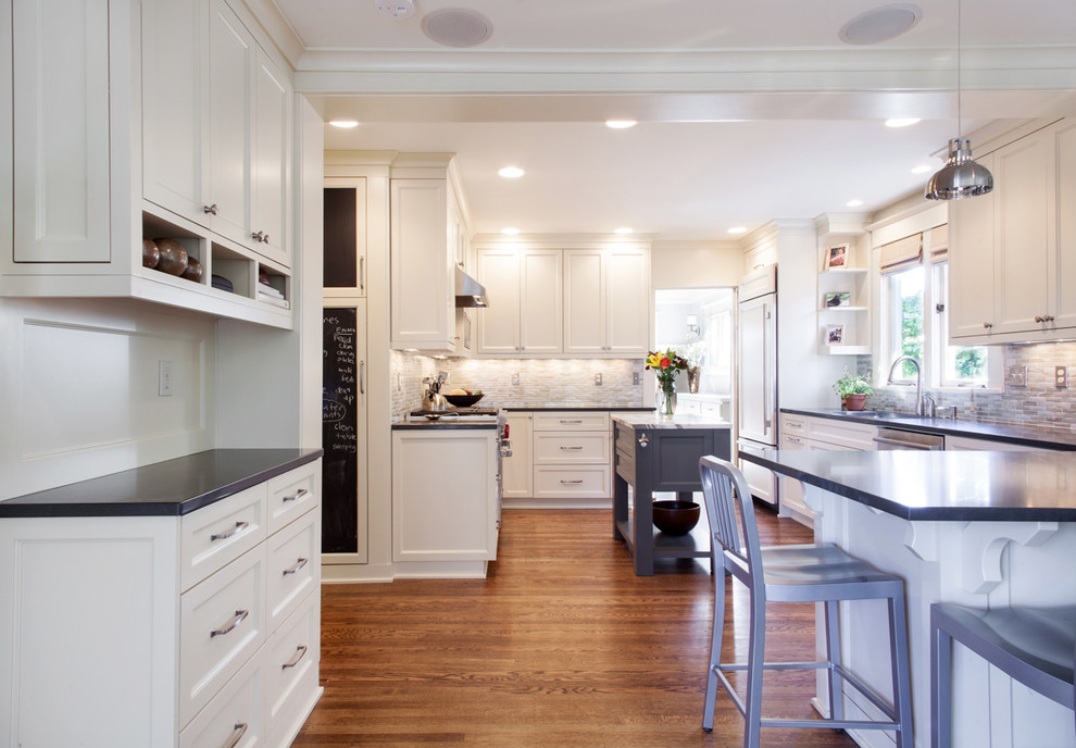 Eat-in kitchen - mid-sized traditional u-shaped medium tone wood floor eat-in kitchen idea in Portland with a single-bowl sink, recessed-panel cabinets, medium tone wood cabinets, quartz countertops, blue backsplash, mosaic tile backsplash, stainless steel appliances and an island