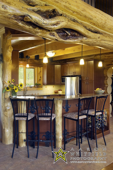 Design ideas for a medium sized rustic open plan kitchen in Other with shaker cabinets, engineered stone countertops, stainless steel appliances and terracotta flooring.
