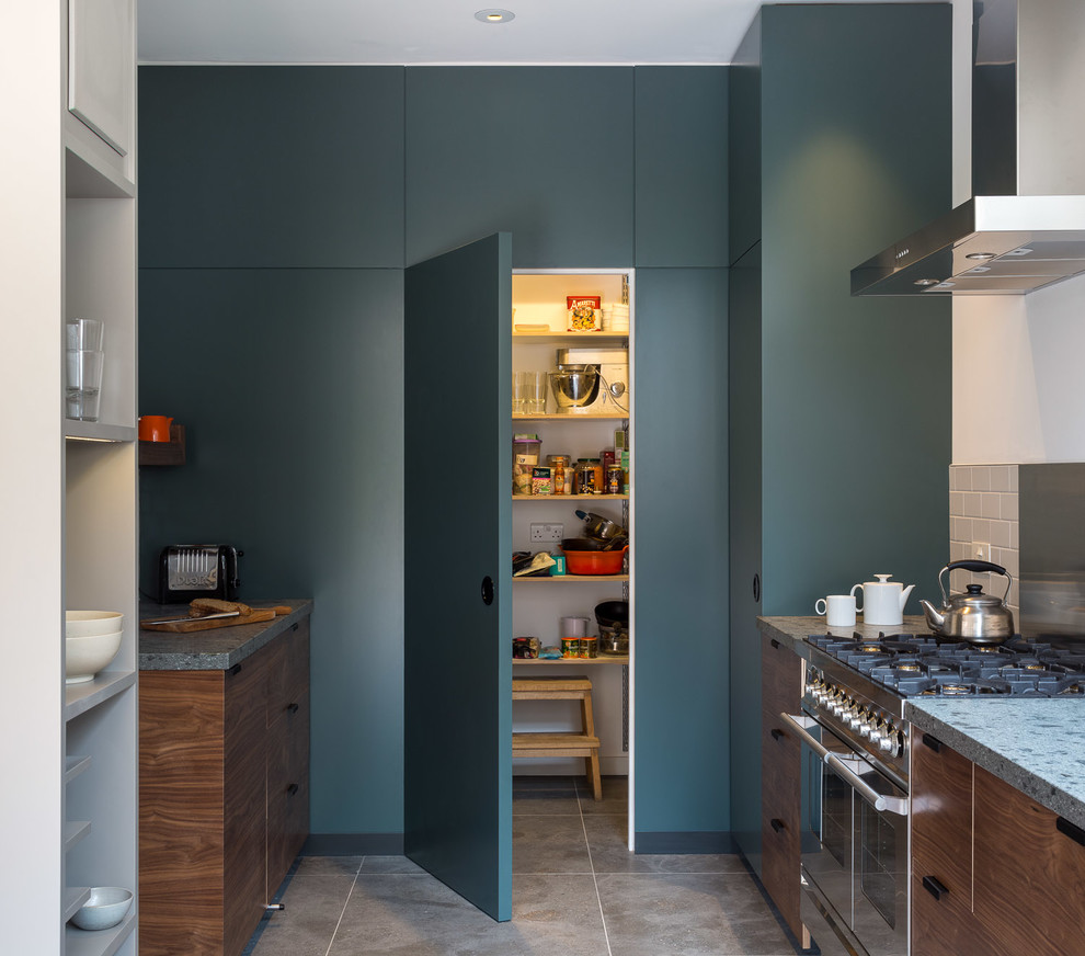 Design ideas for a contemporary single-wall kitchen/diner in London with a built-in sink, flat-panel cabinets, dark wood cabinets, composite countertops, white splashback, cement tile splashback, stainless steel appliances, ceramic flooring and grey floors.