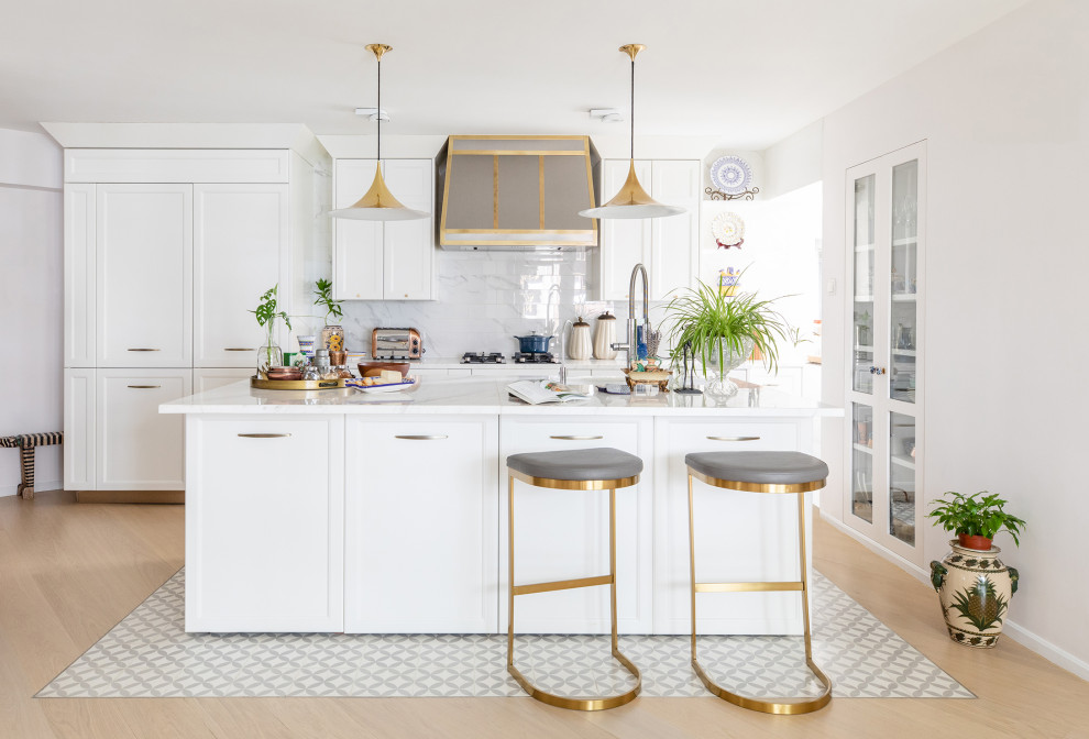 Inspiration for a contemporary galley kitchen remodel in Hong Kong with recessed-panel cabinets, white cabinets, white backsplash, paneled appliances, an island and white countertops