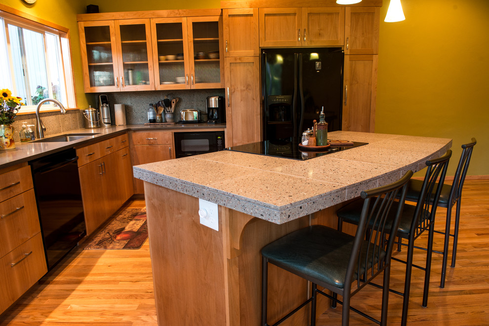 Foto på ett mellanstort vintage grå kök, med en undermonterad diskho, skåp i shakerstil, skåp i mellenmörkt trä, bänkskiva i betong, grått stänkskydd, stänkskydd i cementkakel, svarta vitvaror, mellanmörkt trägolv, en köksö och brunt golv