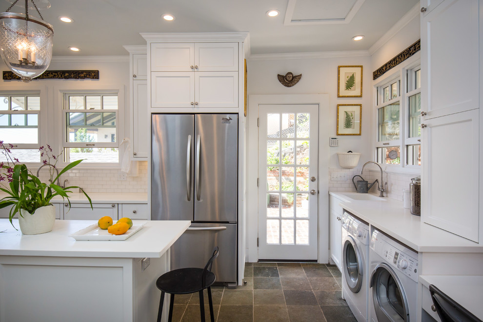 Kitchen pantry - large traditional u-shaped kitchen pantry idea in Hawaii with subway tile backsplash, a double-bowl sink, shaker cabinets, white cabinets, white backsplash, stainless steel appliances and an island