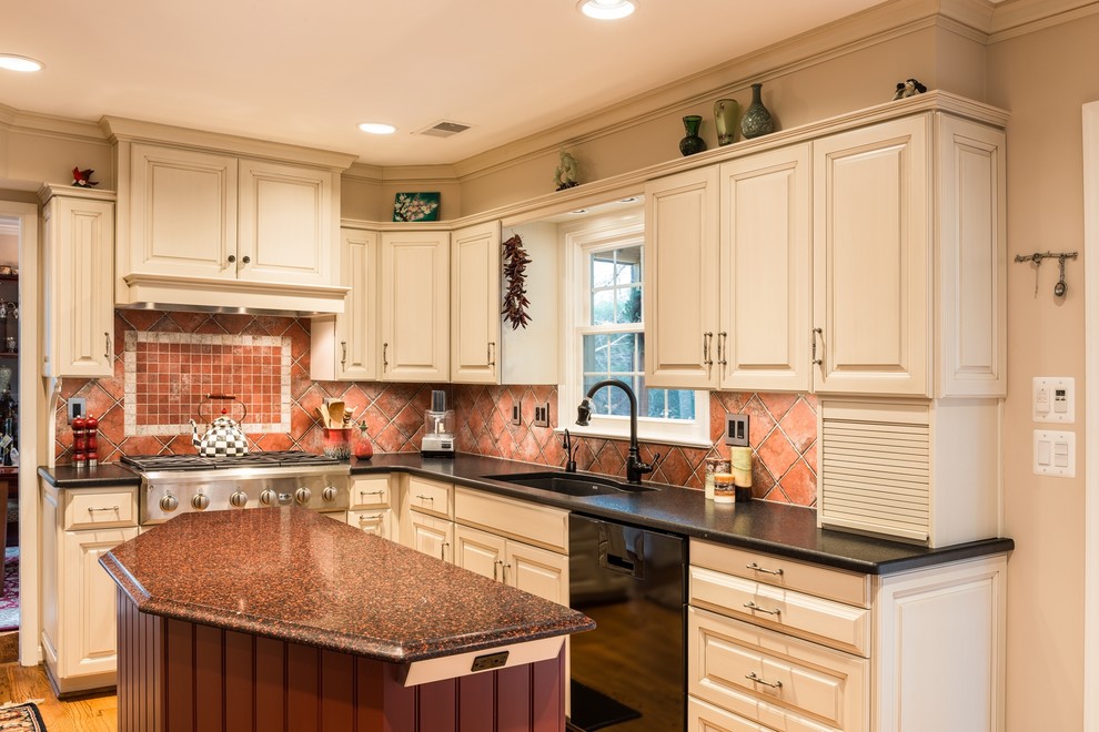 Mid-sized tuscan u-shaped light wood floor eat-in kitchen photo in DC Metro with an undermount sink, raised-panel cabinets, white cabinets, granite countertops, red backsplash, ceramic backsplash, stainless steel appliances and an island