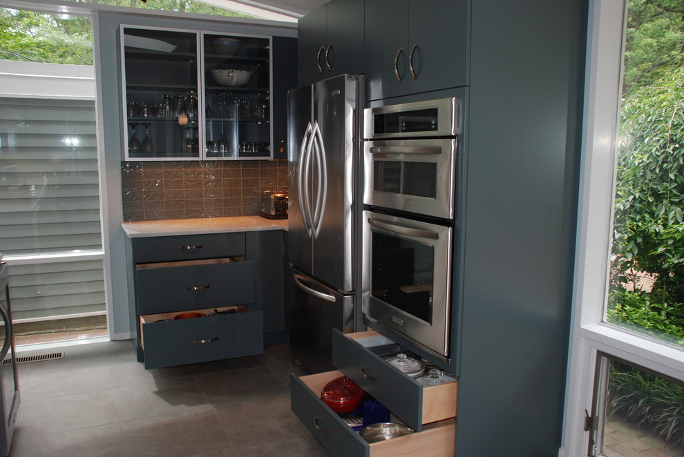 Eat-in kitchen - large 1960s l-shaped porcelain tile eat-in kitchen idea in DC Metro with flat-panel cabinets, gray backsplash, stainless steel appliances, an undermount sink, blue cabinets, laminate countertops, mosaic tile backsplash and no island
