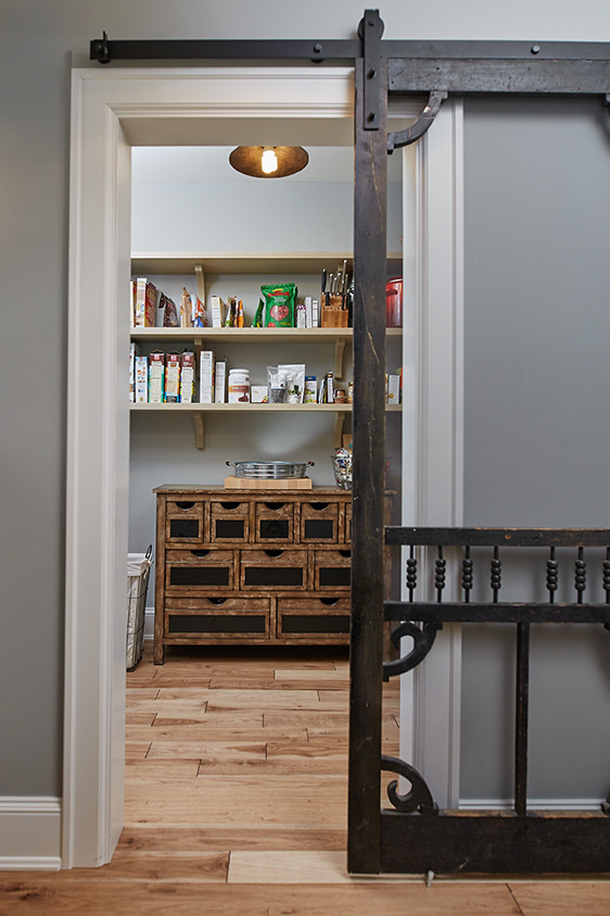 Example of a large transitional medium tone wood floor and brown floor kitchen pantry design in Grand Rapids