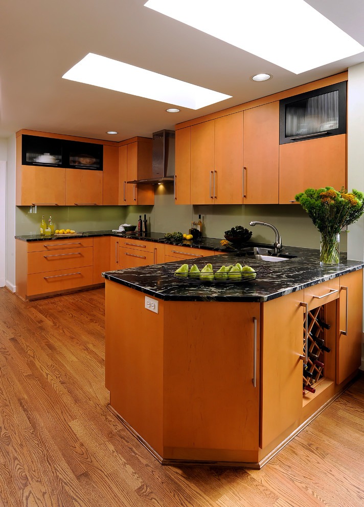 Eat-in kitchen - mid-sized contemporary u-shaped light wood floor and beige floor eat-in kitchen idea in DC Metro with a double-bowl sink, flat-panel cabinets, medium tone wood cabinets, granite countertops, stainless steel appliances, no island, green backsplash and glass sheet backsplash