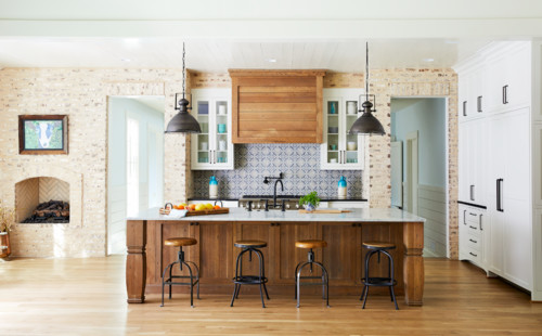 Traditional kitchen with wood island cabinets in polyurethane (PU) finish, featuring marble countertop and industrial pendant lighting