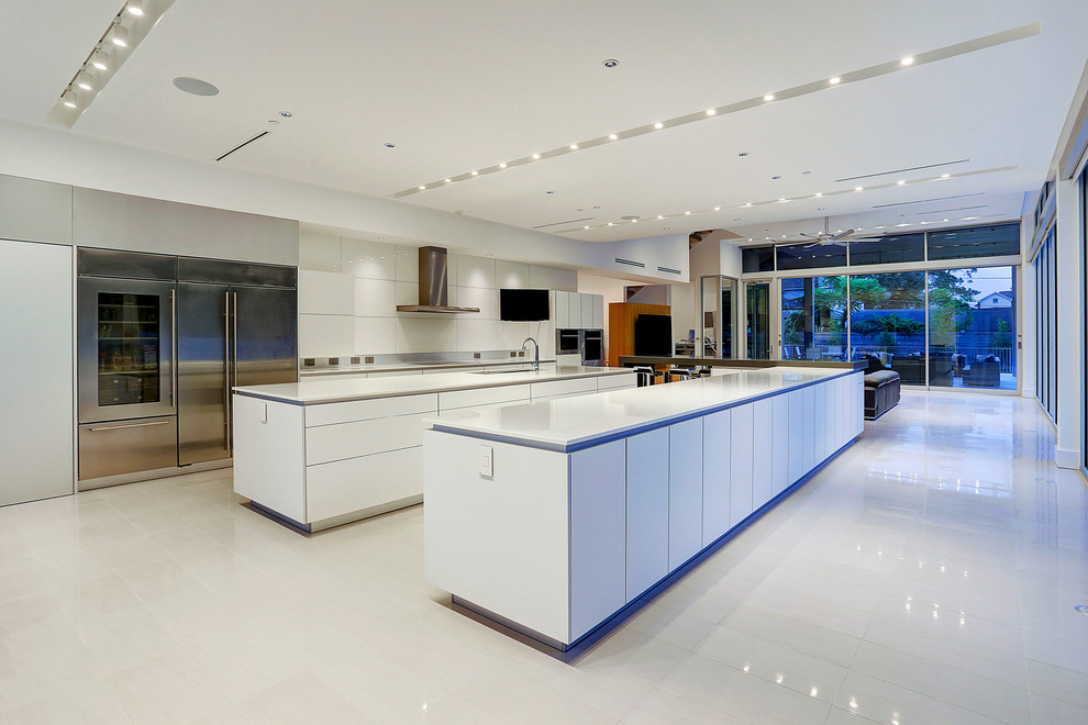 Inspiration for a huge modern single-wall porcelain tile and white floor eat-in kitchen remodel in Houston with flat-panel cabinets, white cabinets, two islands, an undermount sink, solid surface countertops and stainless steel appliances