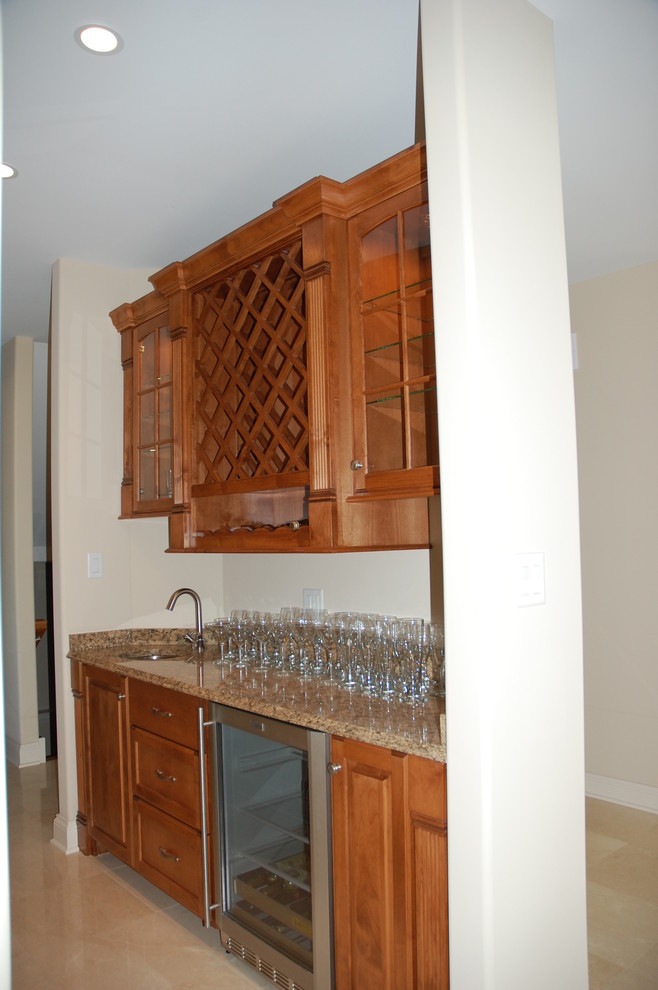 This is an example of a mediterranean u-shaped kitchen/diner in Chicago with a submerged sink, raised-panel cabinets, medium wood cabinets, granite worktops and stainless steel appliances.