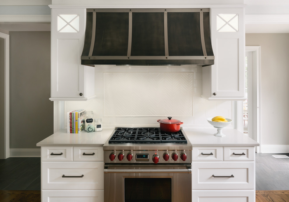 Exempel på ett stort klassiskt kök, med en rustik diskho, luckor med infälld panel, vita skåp, granitbänkskiva, vitt stänkskydd, stänkskydd i keramik, rostfria vitvaror, mörkt trägolv och flera köksöar