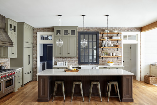 Spacious kitchen featuring a large island, wooden floors, and white ceiling paint color.
