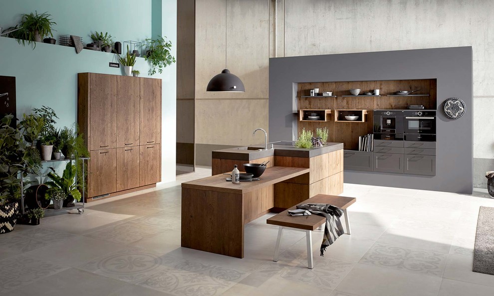 Medium sized retro single-wall open plan kitchen in New York with a submerged sink, shaker cabinets, grey cabinets, wood worktops, brown splashback, wood splashback, cement flooring, an island and grey floors.