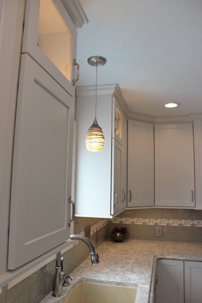 Inspiration for a mid-sized transitional l-shaped vinyl floor and gray floor eat-in kitchen remodel in Other with an undermount sink, flat-panel cabinets, white cabinets, quartz countertops, gray backsplash, subway tile backsplash, stainless steel appliances, an island and multicolored countertops