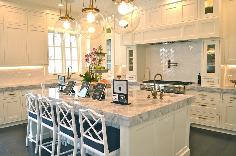 Inspiration for a large transitional l-shaped dark wood floor open concept kitchen remodel in Salt Lake City with a farmhouse sink, shaker cabinets, white cabinets, marble countertops, white backsplash, subway tile backsplash, stainless steel appliances and an island