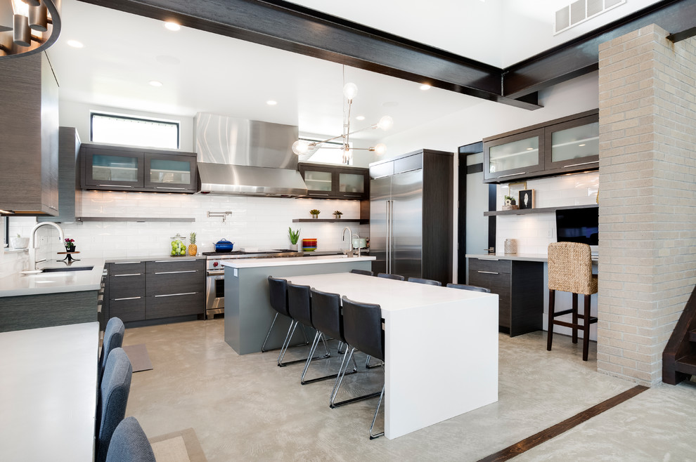 Inspiration for a contemporary kitchen/diner in Salt Lake City with dark wood cabinets, white splashback, stainless steel appliances, multiple islands and beige floors.
