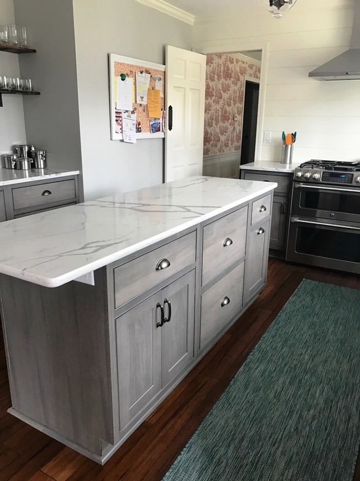 Photo of a medium sized scandi kitchen in Other with recessed-panel cabinets, grey cabinets, engineered stone countertops and an island.