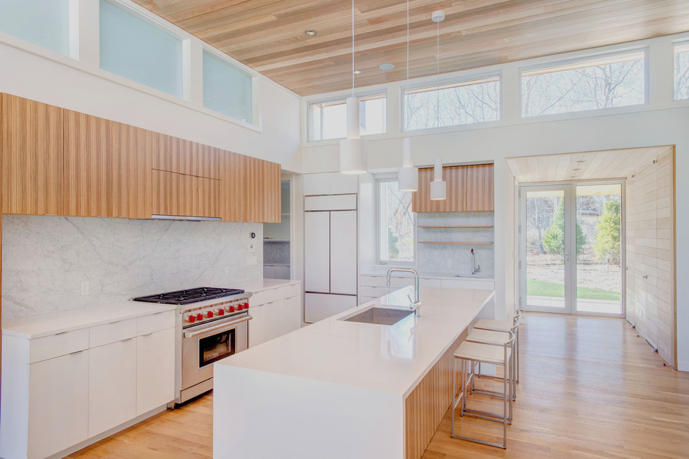 Large minimalist l-shaped light wood floor and beige floor eat-in kitchen photo in New York with an undermount sink, flat-panel cabinets, light wood cabinets, quartz countertops, gray backsplash, stainless steel appliances, an island and marble backsplash