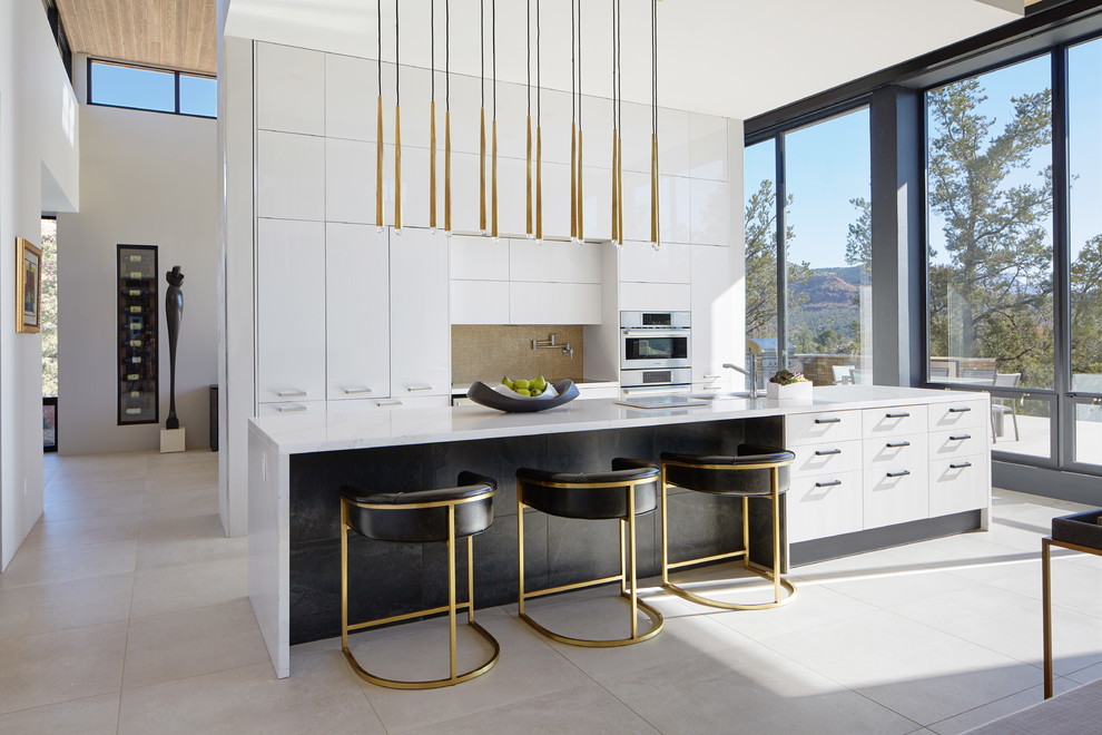 Esempio di una cucina contemporanea con ante lisce, ante bianche, elettrodomestici in acciaio inossidabile, pavimento grigio e top bianco