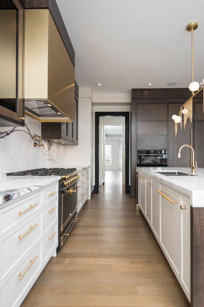 Inspiration for a large vintage open plan kitchen in Toronto with a submerged sink, raised-panel cabinets, dark wood cabinets, marble worktops, multi-coloured splashback, marble splashback, integrated appliances, medium hardwood flooring and an island.