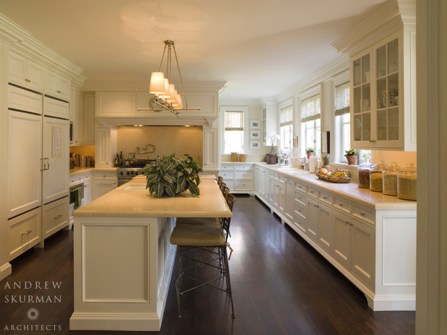 Inspiration for a large timeless galley dark wood floor and brown floor eat-in kitchen remodel in San Francisco with a drop-in sink, beaded inset cabinets, white cabinets, laminate countertops, beige backsplash, stainless steel appliances and an island
