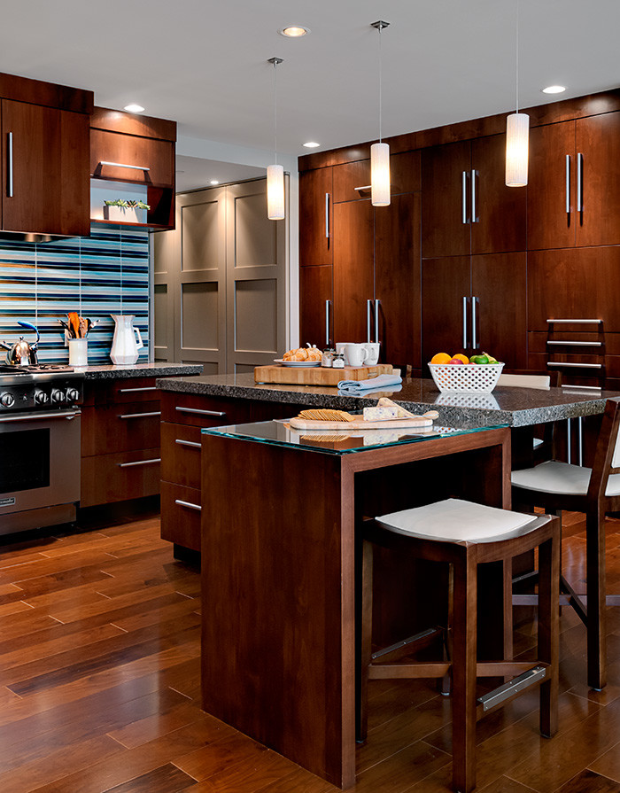 Inspiration for a large contemporary medium tone wood floor kitchen remodel in Boston with flat-panel cabinets, dark wood cabinets, quartz countertops, blue backsplash, ceramic backsplash, stainless steel appliances, an island and a drop-in sink