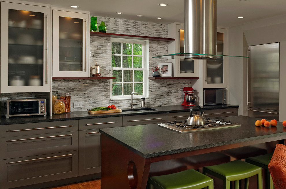 Eat-in kitchen - mid-sized contemporary galley medium tone wood floor eat-in kitchen idea in DC Metro with an undermount sink, multicolored backsplash, stainless steel appliances, an island, shaker cabinets, gray cabinets, granite countertops and stone tile backsplash