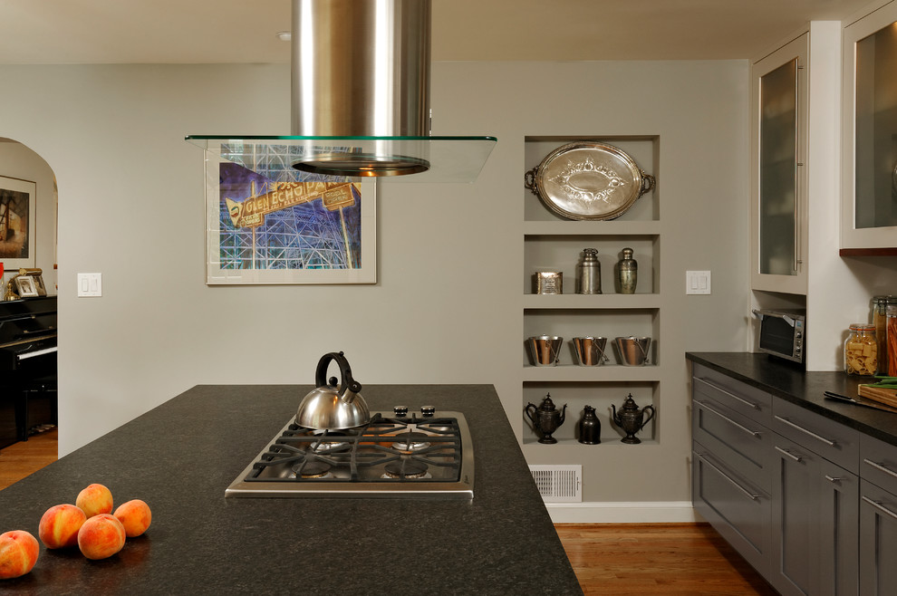 Eat-in kitchen - mid-sized contemporary galley medium tone wood floor eat-in kitchen idea in DC Metro with an undermount sink, gray cabinets, multicolored backsplash, stainless steel appliances, an island, shaker cabinets, granite countertops and stone tile backsplash