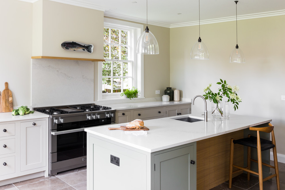 Design ideas for a large traditional galley kitchen in Edinburgh with an integrated sink, shaker cabinets, grey cabinets, engineered stone countertops, white splashback, marble splashback, stainless steel appliances, porcelain flooring, an island, grey floors and white worktops.