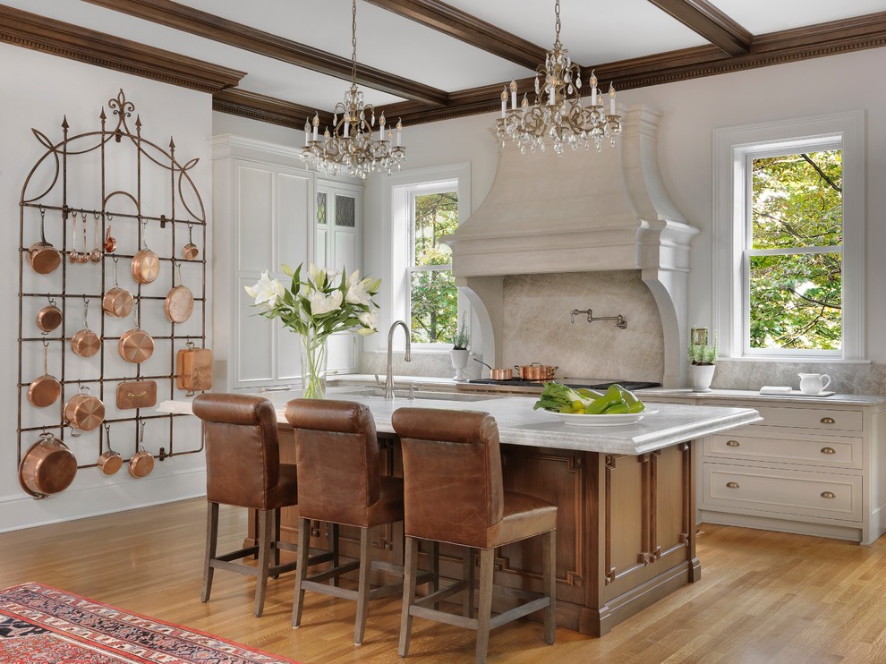 Kitchen - traditional galley medium tone wood floor and brown floor kitchen idea in St Louis with an undermount sink, recessed-panel cabinets, medium tone wood cabinets, white backsplash, stone slab backsplash, stainless steel appliances, an island and white countertops