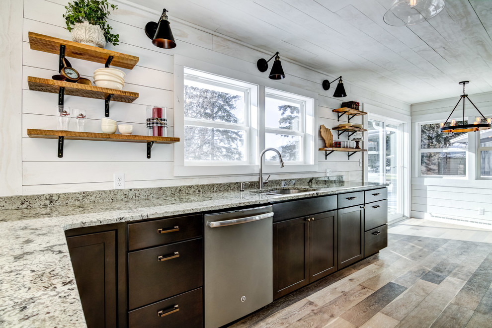 Nautical l-shaped kitchen/diner in Minneapolis with a submerged sink, shaker cabinets, dark wood cabinets, granite worktops, light hardwood flooring and multi-coloured floors.
