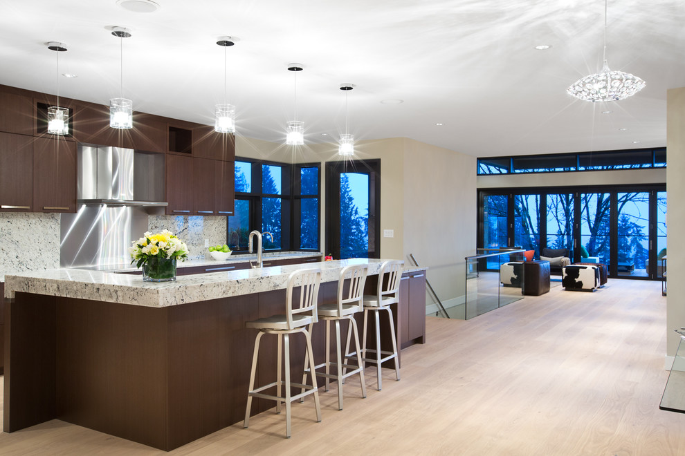 This is an example of a contemporary kitchen in Vancouver with stainless steel appliances and an island.