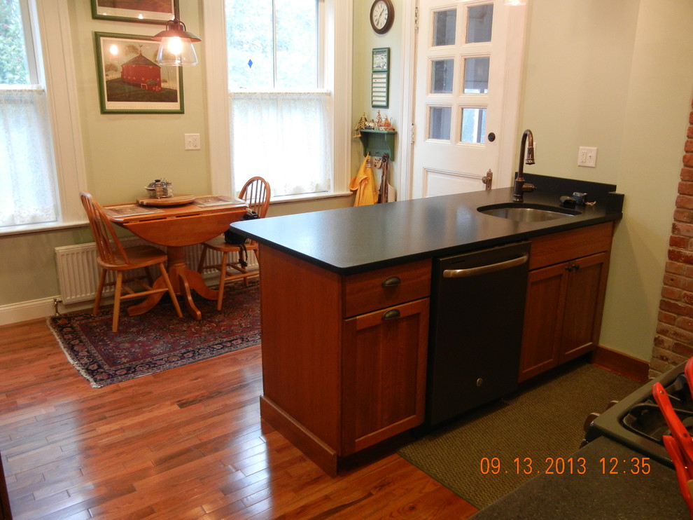Klassische Küche mit hellbraunen Holzschränken, braunem Holzboden und Kücheninsel in Burlington