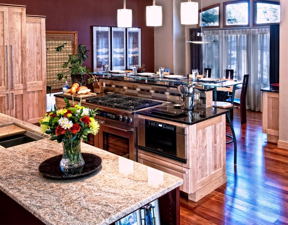 Einzeilige, Große Moderne Wohnküche mit Unterbauwaschbecken, Schrankfronten im Shaker-Stil, hellen Holzschränken, Granit-Arbeitsplatte, Küchengeräten aus Edelstahl, braunem Holzboden und Kücheninsel in Denver