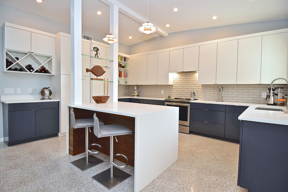 Large trendy u-shaped terrazzo floor kitchen photo in Tampa with a single-bowl sink, flat-panel cabinets, blue cabinets, quartz countertops, gray backsplash, ceramic backsplash, stainless steel appliances, an island and white countertops