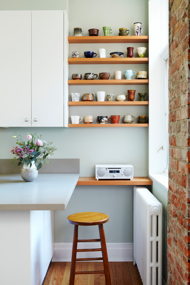 Contemporary kitchen in Toronto with open cabinets, medium wood cabinets, medium hardwood flooring and a breakfast bar.