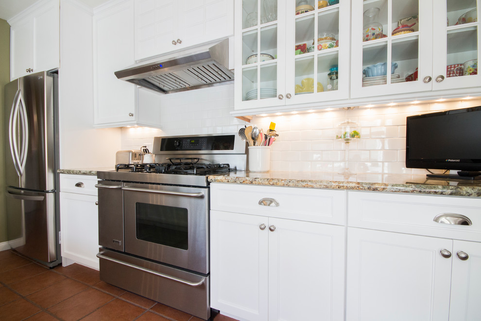 Mid-sized elegant galley terra-cotta tile eat-in kitchen photo in Los Angeles with an undermount sink, recessed-panel cabinets, white cabinets, granite countertops, white backsplash, subway tile backsplash, stainless steel appliances and no island