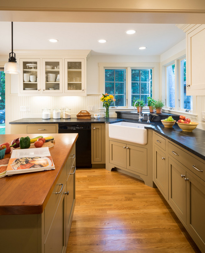 Mid-sized cottage u-shaped light wood floor eat-in kitchen photo in Boston with a farmhouse sink, shaker cabinets, white cabinets, soapstone countertops, white backsplash, subway tile backsplash, stainless steel appliances and an island