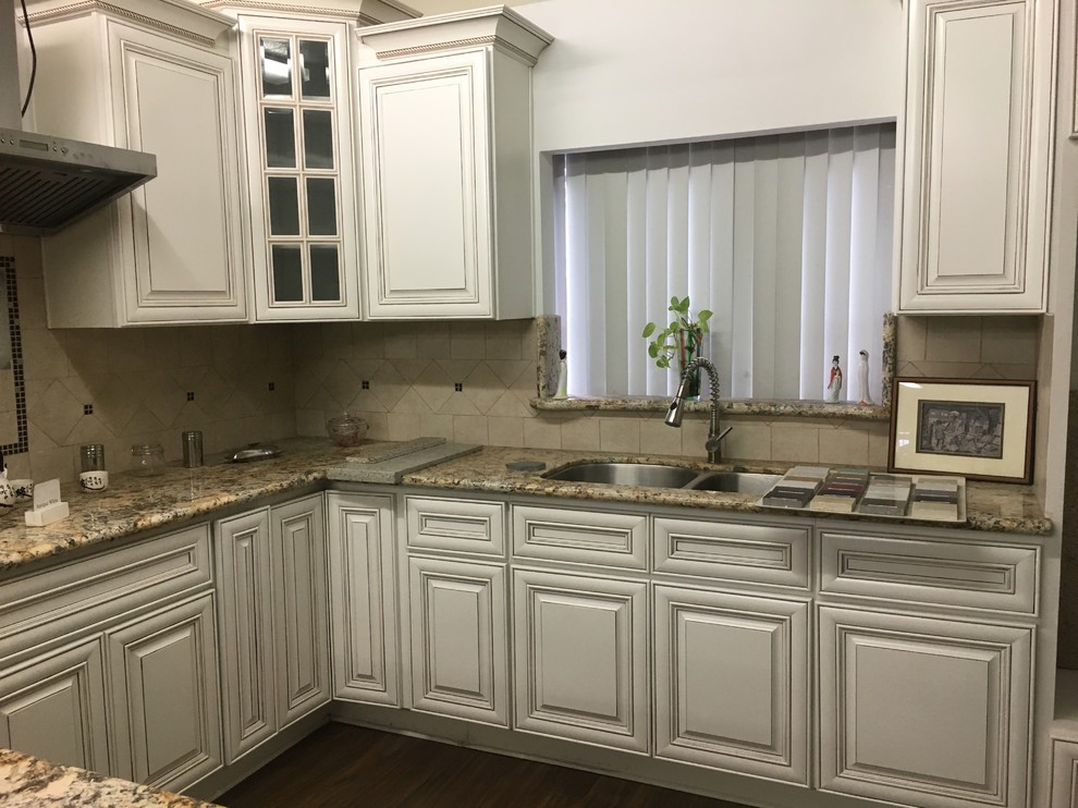This is an example of a large victorian u-shaped kitchen/diner in Los Angeles with a double-bowl sink, flat-panel cabinets, white cabinets, granite worktops and no island.
