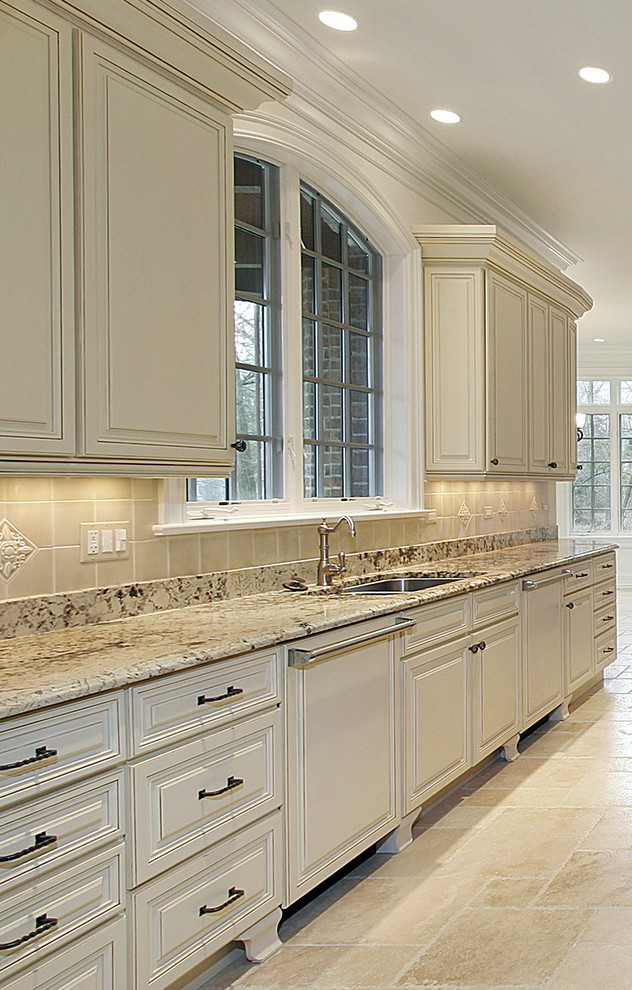 Eat-in kitchen - mid-sized traditional galley marble floor eat-in kitchen idea in Toronto with an undermount sink, raised-panel cabinets, white cabinets, granite countertops, beige backsplash, ceramic backsplash and paneled appliances